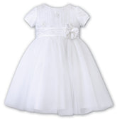 Sarah Louise Ceremonial Ballerina Dress in white, a delicate hand-pleated bodice with clusters of flowers adorned with pearls and a beautiful Satin flower at the waist.